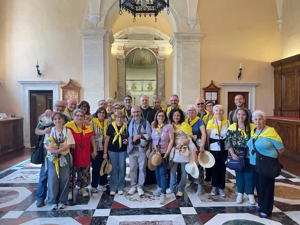 Gruppo con foulard gialli in una chiesa durante un pellegrinaggio
